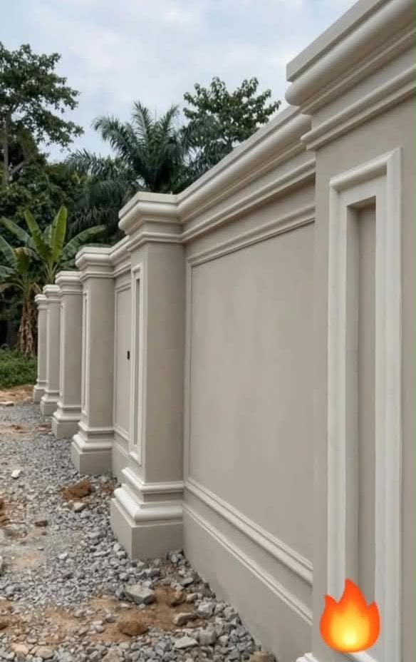 Long fence wall with moulded pillars, flower caps and panel frames
