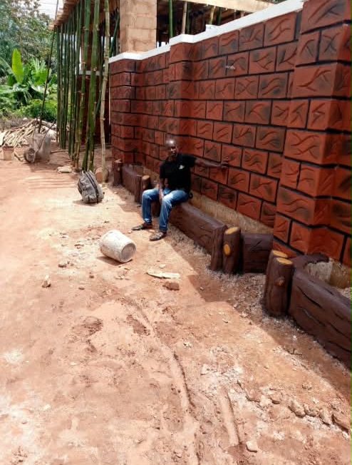 Red brick-pattern wall with log-effect planter edging