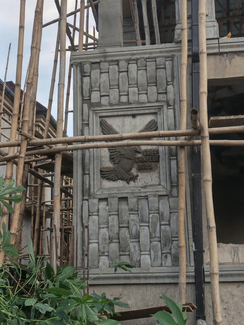 Eagle relief panel with a name inscription, framed by moulded stonework