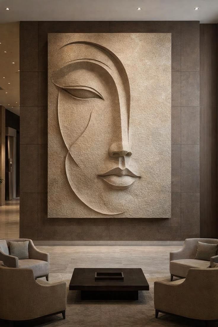Large textured wall relief of a stylised face in a hotel lounge