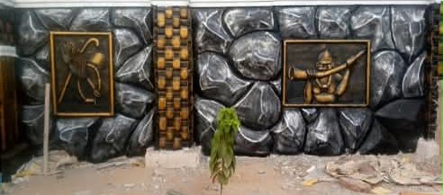 Black and silver rock-relief wall with two bronze-finish framed relief panels